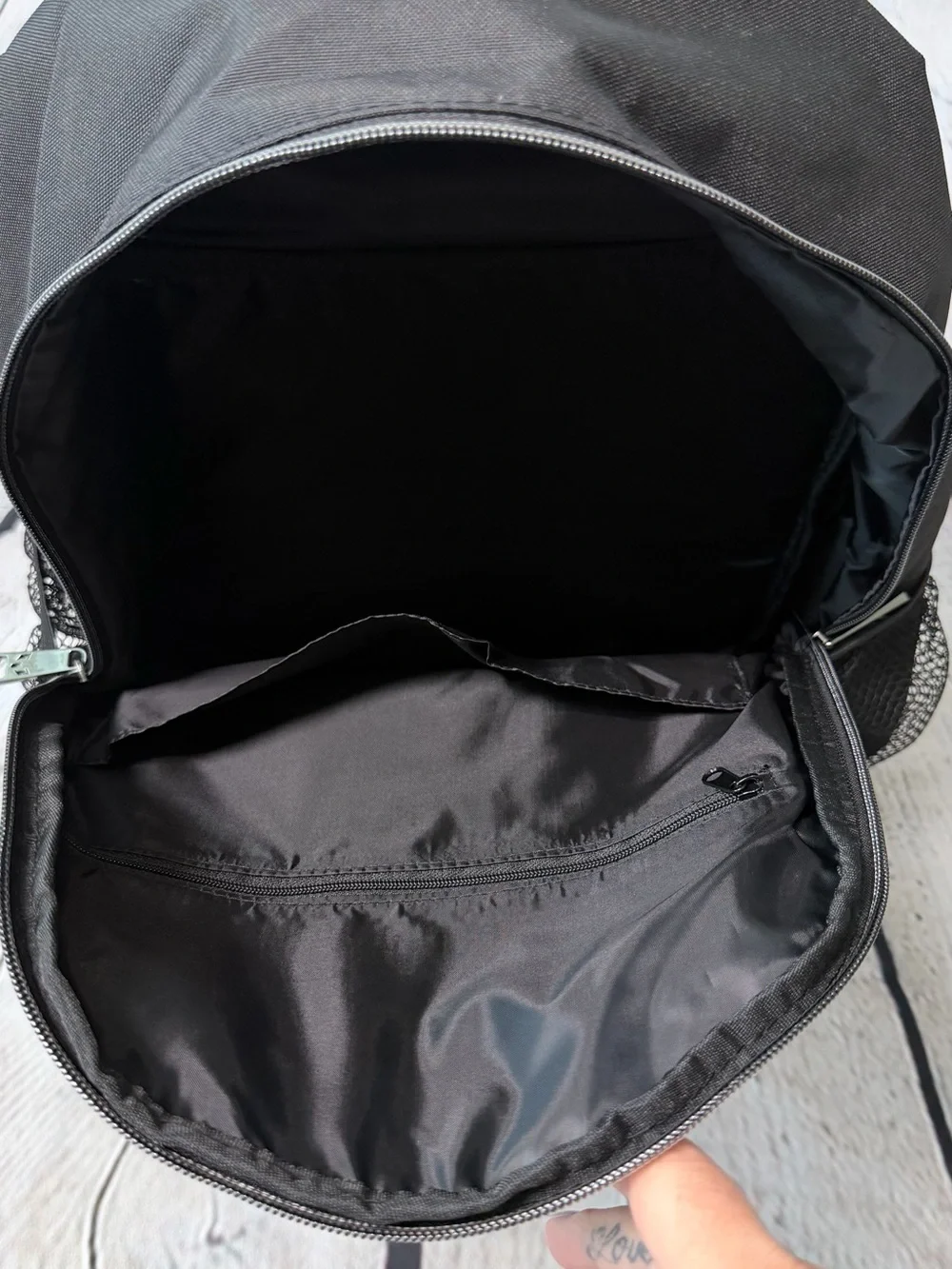 Black Messi backpack with graphic of a soccer player in action